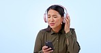 Music, phone and face of woman with questions, headphones or ask gesture on studio blue background. Podcast, gossip and portrait of Asian female model with speak up emoji while streaming radio track 
