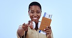 Woman, passport and plane ticket in studio for smile, come or welcome for travel with face by blue background. African person, documents and compliance with point, invitation or happy for immigration
