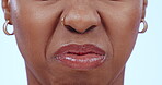 Woman, face and nose with stink or bad smell, closeup of reaction and odor in air with gas or fail on blue background. Fart, trash or garbage stench, emoji and negative facial expression in studio