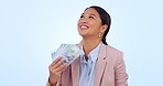 Money fan, success and face of business woman in studio happy with startup, loan or profit on blue background. Cash, payment and portrait of Asian female entrepreneur with financial investment growth