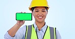 Green screen phone, construction worker and a woman with mockup for contact or app information. Smile, face portrait and a female logistics employee with space on a mobile and studio background