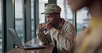 Black man typing on laptop in coffee shop, drink in mug and reading email on internet, web and search. Computer, freelance and copywriter in cafe with tea cup, remote work and writing blog at table