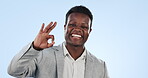 Ok, hand and face of black man with sign for yes in studio with emoji for thank you or agreement in business. Portrait, businessman and review symbol or icon for satisfaction and positive feedback
