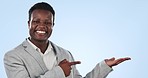 Happy black man, palm and pointing in advertising or marketing against a blue studio background. Portrait of African businessman smile showing product, promotion deal or information on mockup space