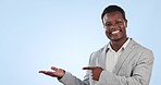 Black man, pointing and palm in business, advertising or marketing against a blue studio background. Portrait of happy African businessman smile showing product, information or deal on mockup space