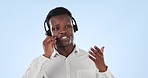 Black man, call center and consulting on headphones in customer service against a blue studio background. African businessman, consultant or agent talking on headset in online advice on mockup space