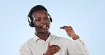 Black man, call center and consulting in customer service or telemarketing against a studio background. African businessman, consultant or agent talking on headphones in online advice on mockup space