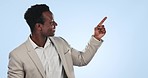 Happy businessman, pointing and list in advertising or marketing against a blue studio background. Portrait of African or black man smile and showing options, steps or information on mockup space