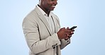 Business man, phone text and smile from social media and web networking in a studio. African male entrepreneur, professional and app for work happy from website post scroll and blue background