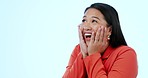 Surprise, happy and excited woman with laughing, mockup space and discount deal in a studio. Wow, shock and female person with smile from japan with sale announcement and winning with blue background
