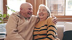 Senior, couple or hug with laugh on sofa for romance, commitment or relationship in living room of home. Elderly, man or woman with embrace and happiness on couch for love, care and support in lounge