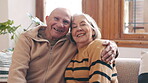 Elderly, couple or hug with laugh on sofa for romance, commitment or relationship in living room of home. Senior, man or woman with embrace and happiness on couch for love, care and support in lounge