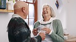 Senior couple, laughter or coffee in conversation in kitchen, love or joke in retirement. Elderly man, woman or marriage to espresso drink in morning, relax together or calm, comedy talking in house