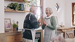 Cooking, singing and senior couple in kitchen for lunch, supper and romantic dinner together. Marriage, retirement and man and woman at home with food for meal prep for bonding, fun and dancing