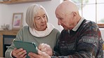 Senior couple, tablet and showing in living room with social media, technology and online subscription. Elderly man, woman and touchscreen with discussion in apartment, streaming and digital network