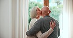 Window, kiss or old couple hug with support, love or care in marriage, retirement or morning. Back, romantic mature man or senior woman bonding together on holiday vacation break to relax at home