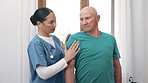 Nurse, patient and shoulder for physiotherapy in hospital with rehabilitation for recovery. Elderly man, medical professional and discussion by massage for injury in nursing home for care in wellness