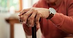 Closeup, home and senior man with walking stick, shaking and retirement in a living room. Pensioner, person with disability and old guy with a cane, anxiety and parkinsons with treatment and recovery