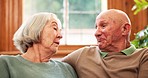 Senior, couple or communication for happy on sofa, marriage or care for support in living room. Elderly man, woman or smile in talking to relax, retirement love or discussion together in family home