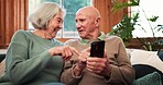 Senior couple, smartphone and talking in home to scroll online, reading notification and news app on sofa. Happy old man, woman and typing on cellphone, social media and mobile contact in living room