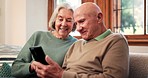 Reading, phone and senior couple relax in home with app or streaming a video on social media with internet. Scroll, cellphone and people in retirement with funny meme online or news in living room