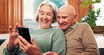 Relax, online and senior couple on sofa with phone, app or streaming a video on social media with internet. Reading, cellphone and people in retirement with funny meme or scroll news in living room