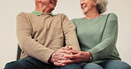 Home, talking and senior happy couple holding hands for romantic care, support or partner trust, love or funny conversation. Chat, bonding and marriage people laughing together at relationship joke