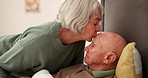 Sick, kiss forehead and senior couple for support, bonding and compassion at home for rehabilitation. Retirement, marriage and elderly man care for woman with illness, healing and recovery in bedroom