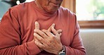 Heart attack, hands and senior man on sofa with lungs, problem or breathe, risk or emergency closeup. Chest pain, zoom and elderly person with anxiety, asthma or heartburn, stress or panic in a house