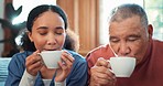 Coffee, relax or visit with a nurse and patient on a sofa in the living room of a home for assisted living. Face, tea or charity with a woman volunteer and senior man in an apartment for retirement