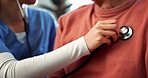 Woman, nurse and hands checking heart beat in elderly care, living room or healthcare at home. Closeup of female person, doctor or medical caregiver monitoring senior patient breathing at house