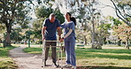 Walking, senior man and nurse help outdoor in garden, park or woods with woman, support and conversation in retirement. Caregiver, helping and guide elderly person with walker, physio and healthcare