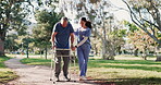 Senior man, walking and nurse help in garden, park or outdoor woods with woman, support and conversation in retirement. Caregiver, helping and guide elderly person with walker, physio and healthcare