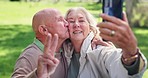 Peace sign, selfie and senior couple kiss at park for love, support and bonding together for care. V hand, happy elderly man and woman in garden for photography, picture and romance outdoor in nature