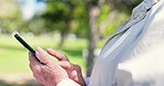 Phone, typing and senior person in park for mobile app for health, cardio and wellness outdoors. Retirement, fitness and closeup of hands with smartphone for social media, online chat and networking