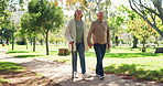 Mature couple, retired and walking in park for wellness, heart health and outdoor. Retirement, enjoying and love for husband, wife and hand holding for support, care and bonding together in nature