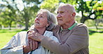 Senior, couple and hug or talking in park with embrace, conversation and bonding for retirement. Elderly, man or woman outdoor in nature with communication, love and discussion for relax or date