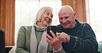 Phone, comic and senior couple on sofa laughing at meme, joke or gif message in their home together. Funny, love and old people with smartphone, app or joke in a living room having fun in retirement