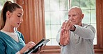 Physical therapy, senior man and tablet with stretch and wellness exercise for health at hospital. Physiotherapist, healing and elderly patient with consultation and assessment for care and support