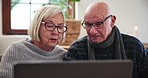 Senior, couple and laptop with discussion for planning, investment or schedule for retirement in living room. Elderly, person or technology, communication and research at table in lounge with smile