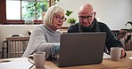 Senior, couple and laptop with communication for planning, investment or schedule for retirement in living room. Elderly, person or notebook with technology and research at table in lounge of home