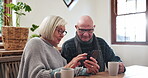 Senior couple, browse smartphone and home for discussion with technology, relax and learning in retirement. Elderly man, woman or cellphone for online connection, conversation or search social media