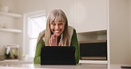 Senior, woman and video call on tablet with wave for communication, speaking and conversation in kitchen at home. Elderly, person and touchscreen for networking, technology and connection in house