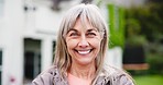 Happy, face and senior woman in a garden at retirement home for outdoor fresh air or exercise. Smile, confident and portrait of elderly female person standing in nature in her backyard at her house.