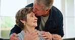 Senior couple, forehead kiss and love closeup in a home in retirement and marriage with hug, care and support. Trust, elderly woman and man in a living room with embrace and relax with commitment