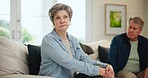Senior couple, sitting and fighting on divorce, stress and conflict on couch in living room. Elderly people, arguing and angry for cheating, affair and erectile dysfunction in sex, mad and whatever