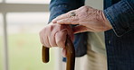 Senior, cane and closeup of hands with arthritis, walking support and feeling for pain. House, skincare and an elderly person touching the fingers for a problem, massage or health with a stick