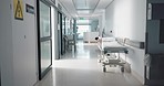 Healthcare, hospital and empty corridor with bed for medical care, health insurance and help in surgery. ER, emergency and lobby at clinic with stretcher for wellness, service and support in medicine