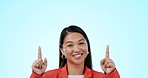 Happy, pointing and face of woman in studio with mockup for marketing, promotion or advertising. Smile, excited and portrait of Asian female model with show hand gesture isolated by white background.