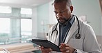 Healthcare, black man and doctor with a tablet, internet or connection with online reading, digital app or check results. Person, employee or medical professional with tech, research and internet